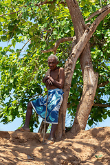 Image showing Old man rests in the shade near a ferry crossing the river in Belo Sur Tsiribihina, Madagascar