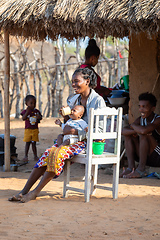 Image showing Malagasy woman in Kivalo village feed her baby. Madagascar