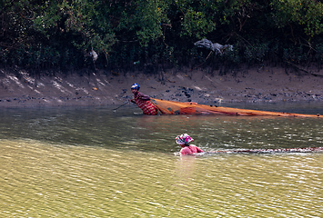 Image showing Malagasy woman fishing in a river. Morondava, Madagascar