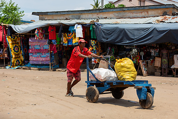 Image showing Man pushing cart with bags on street of Miandrivazo in Madagascar