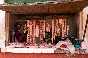 Image showing Woman buys meat from a street butchery in Mandoto, Madagascar.