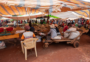 Image showing Malagasy man buys dried fish at a street market. Fishing is one of the livelihoods in Madagascar.