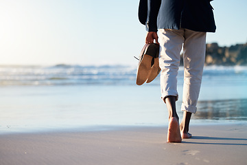 Image showing Walking, beach and mental heath with a business man walking in the sand by the sea or ocean after work. Water, nature and freedom with a male employee taking a walk on the coast during summer