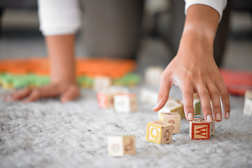 Image showing Hands, cleaning and toys with a woman or mother picking up building blocks in the house to clean or tidy. Hand, responsible and object with a female cleaner working on a home floor for housework