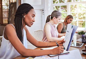 Image showing Black woman with business documents, writing at desk and women working together on audit report at startup. Diversity, teamwork and success, reading small business project proposal and taking notes.