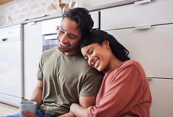 Image showing Relax, smile and couple with coffee in the morning on the floor of kitchen in their house. Happy and young man and woman with love, marriage and happiness in their home with tea for calm and peace