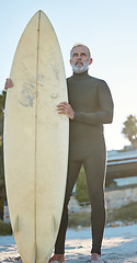 Image showing Beach, board and surfer on holiday by the ocean of Costa Rica with idea for adventure in retirement during summer. Mature man surfing on travel vacation by the sea and tropical ocean for health