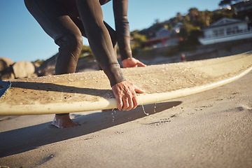 Image showing Hands, surfboard and beach surfer man on holiday, vacation or summer trip in Hawaii. Fitness, workout and male pick up board ready for surfing sports, fitness or exercise by sandy seashore outdoors.