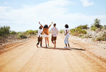 Image showing Freedom, desert and friends walking outdoor in nature on a road trip vacation in the countryside. Travel, happy and group of people on outside dirt road adventure together on a holiday in Australia.