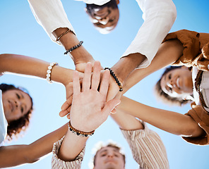 Image showing Friends, trust and support hands low angle for solidarity in multicultural group with blue sky. Care, respect and love in friendship with young people who enjoy happy emotional bond together.