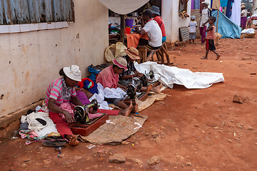 Image showing Street tailors work with their outdated manual sewing machines. Earn some money in Madagascar is very difficult