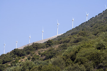 Image showing Wind turbines against blue sky