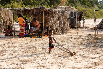 Image showing Boy have fun with a simple toy on wheels at the ferry port in Bekopaka. Madagascar