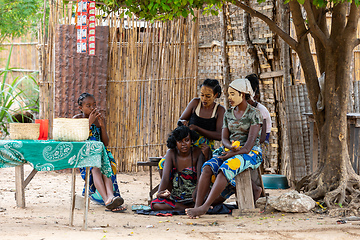 Image showing Malagasy woman hairstyling in front of her hut resting in shaddow. Bekopaka, Madagascar