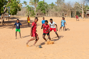 Image showing Children from Kivalo village playing soccer with a handmade textile ball behind their school.
