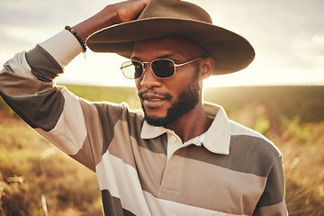 Image showing Farm, agriculture and sustainability with a black man in a field, meadow or grass while farming in nature. Farmer, agricultural and sustainable with a young male working on land for organic produce