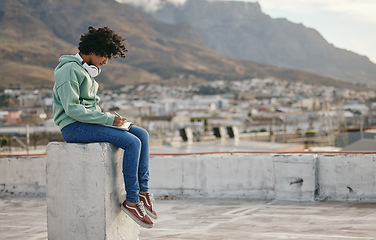 Image showing Freedom, book and writing girl on outdoor rooftop for diary inspiration, motivation and peace on Cape town roof building. Pen, notebook and relax for young gen z woman, artist or creative journal