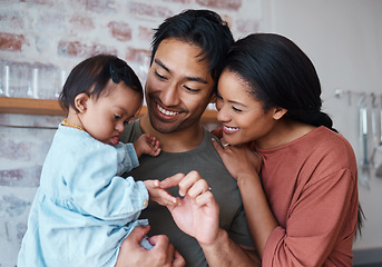 Image showing Family with down syndrome baby, happy parents in kitchen home together and young child care. Indian father holding cute kid, asian mother smile with support and bonding happiness in Brazil house