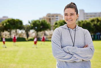 Image showing Sports, soccer and coaching with woman on football field with arms crossed for training, fitness or teamwork leadership. Motivation, support and smile with coach and kids athlete for goals and health