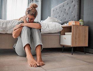 Image showing Crying, sad and depressed woman on bedroom floor using wipe for tears struggling with mental health, depression and anxiety after heartbreak or breakup. Upset or sick female cry about problem at home