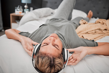 Image showing Relax on bed, woman with headphones and streaming music online. Radio, podcast and content for entertainment on the internet. Girl with free time listening on earphones in bedroom at home in peace.