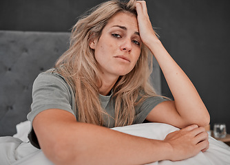 Image showing Depression, tired and portrait of a sick woman sitting on the bed in her bedroom at home. Anxiety, mental health problem and exhausted girl crying with insomnia, headache and burnout at her house.