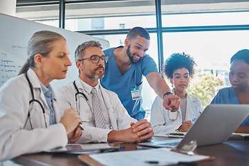 Image showing Teamwork, diversity and doctors in a meeting planning a surgery strategy in collaboration together on laptop in an office. Medical healthcare workers in conversation about cardiology report review