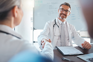 Image showing Doctor handshake, medical welcome and man consulting with team for healthcare planning at hospital. Mature employee working in medicine meeting a consultant for collaboration and help at clinic