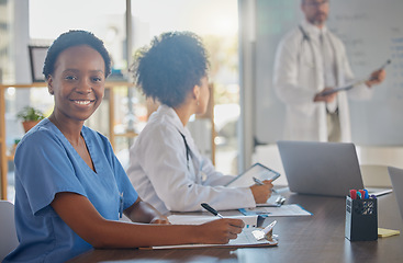 Image showing Medical meeting, portrait and African doctor writing notes in a nursing workshop for training at a hospital. Happy, professional and black woman nurse in a seminar for medicine at a clinic at work