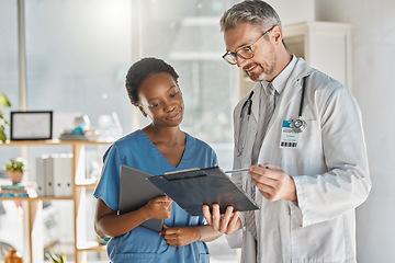 Image showing Student nurse and doctor document review in hospital for professional opinion on treatment. Medical people working together for efficient healthcare strategy, communication and understanding.