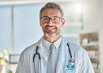 Image showing Doctor, smile and office working at hospital, clinic or medical facility. Medic, man and happy at work with stethoscope, glasses and happiness on face in portrait at healthcare center in Atlanta