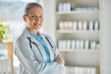 Image showing Medical portrait, healthcare doctor and woman with smile for working in medicine at a pharmacy. Happy, mature and expert pharmacist with arms crossed and pride while consulting in a hospital