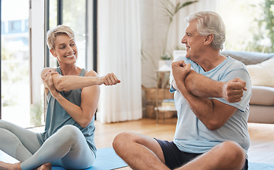 Image showing Stretching, home fitness and senior couple training together on the living room floor in the house. Happy elderly man and woman doing yoga, pilates exercise and cardio for body health in the lounge