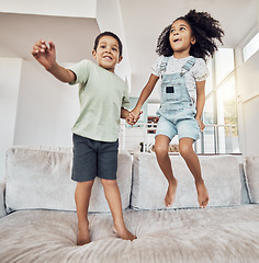 Image showing Children, brother and sister bonding and jumping on sofa in house, home or hotel living room in fun, play and energy game. Smile, happy or adhd kids or hyperactive Mexico boy and girl with sugar rush