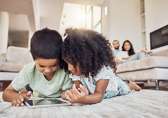 Image showing Children, brother and sister on tablet watching, learning or streaming educational videos, games or cartoon on lounge carpet at home. Kids playing on internet for fun and entertainment in brazil