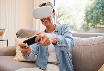 Image showing An elderly woman, virtual reality gaming and in retirement playing 3d online game in the living room of house. Senior grandmother in metaverse, vr technology and racing esports on sofa from her home