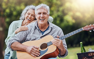 Image showing Couple, guitar and picnic with a senior man and woman in nature with a smile and music for fun. Happy, retirement and love with an elderly male and female pensioner in a park with an instrument