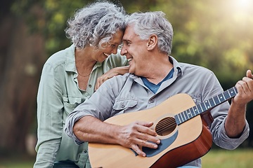 Image showing Senior couple, guitar and love in a park together playing a romantic, love or affection music song for wife. Romance, retired senior man and woman play string instrument and laugh outdoor in forest