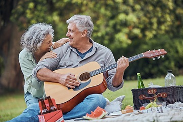 Image showing Music, guitar and a senior couple on picnic in park laughing with food, drinks and romance in retirement. Nature, love and elderly man and happy woman on romantic date on the grass on summer weekend.