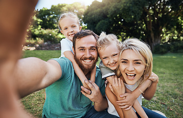 Image showing Nature, selfie and portrait of a happy family on a picnic together in outdoor green garden. Happy, smile and parents playing, hugging and bonding with children outside in backyard or park in canada.