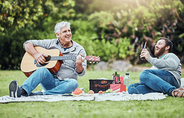 Image showing Guitar, father and son on park picnic with beer and music during holiday in Australia in summer. Senior dad and man laughing at comic sound on instrument while happy on vacation in a nature garden