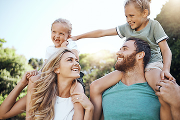 Image showing Mom and dad with kids on their shoulder in the garden, playing together. Love, young and happy family bond and have fun in a park on a summer day. Father, mother and daughters enjoy being in nature