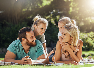 Image showing Picnic park and family with children relax on grass together for outdoor bonding, love and care with sunshine summer lens flare and trees. Nature, healthy and support parents with girl kids on ground