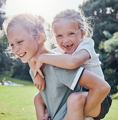 Image showing Happy, smile and siblings in an outdoor park during summer having fun and playing in nature. Happiness, excited and girl children on an adventure giving a piggy back ride outside in a green garden.