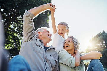 Image showing Grandparents playing together with a girl in the park in the morning. Family, love and grandchild bonding with grandmother and grandmother in a garden. Child holding hands with senior couple outside