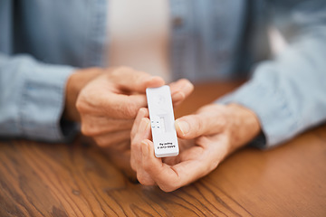 Image showing Covid, healthcare and rapid antigen test in the hands of a man at home testing for infection and waiting for results. Health, medical and insurance with a testing kit for corona and examination