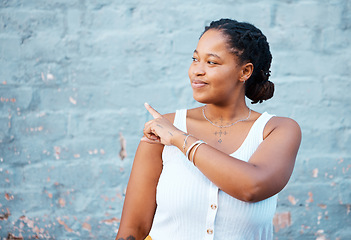 Image showing Black woman pointing finger to show advertising, promo or commercial mockup, marketing space on blue wall outdoor gen z, youth lifestyle. African girl or student with hand sign to information mock up