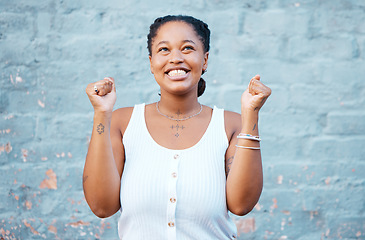 Image showing Happy black woman, smile and winner in success for victory. deal or prize against a wall background. Excited African female smiling in celebration happiness for winning achievement with arms raised