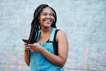 Image showing Smartphone, digital networking and black woman with mobile app, social media post or 5g internet outdoor with mock up blue wall. Happy african gen z girl typing on her cellphone for youth online blog