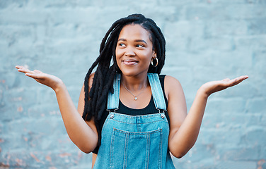 Image showing Model, smile and hands for gesture of confusion pose in street against blue wall. Black woman, question and confused sign in city against urban background with dreadlocks in Cape Town, South Africa